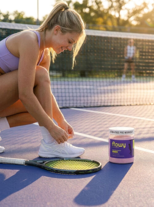 Tennis player lacing up beside a tub of Flowy